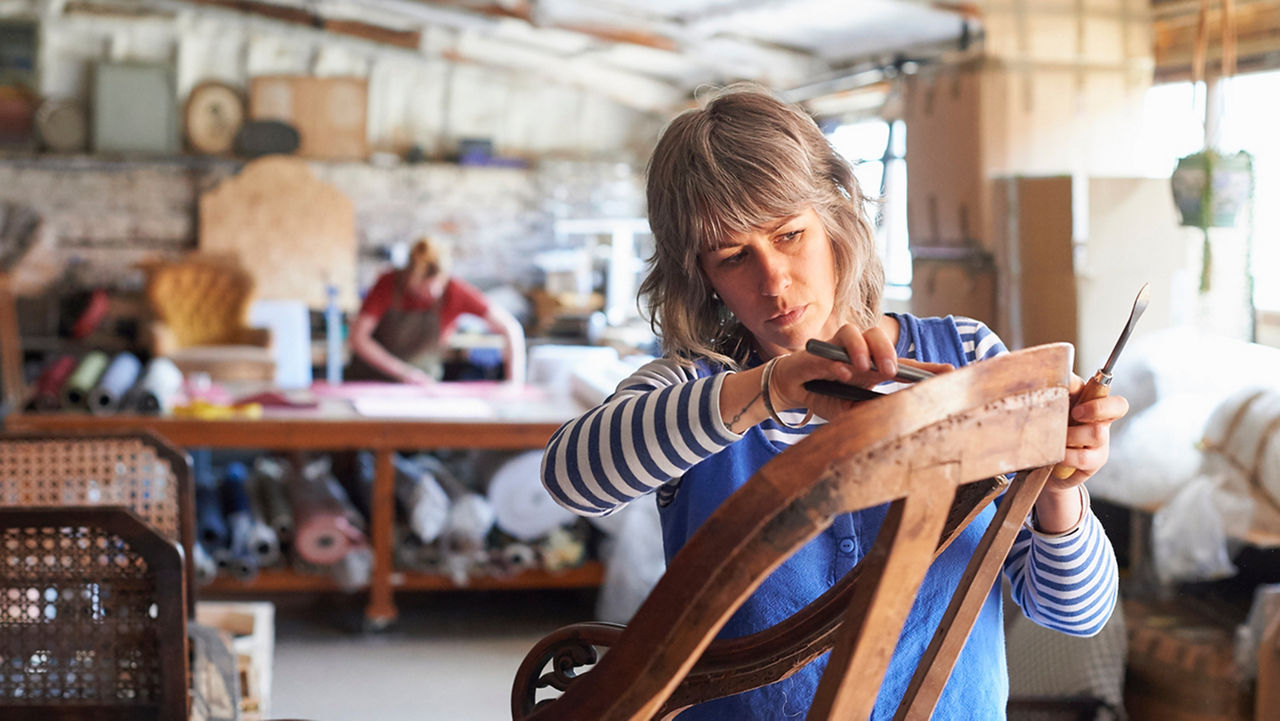 Woman creating art with woodwork