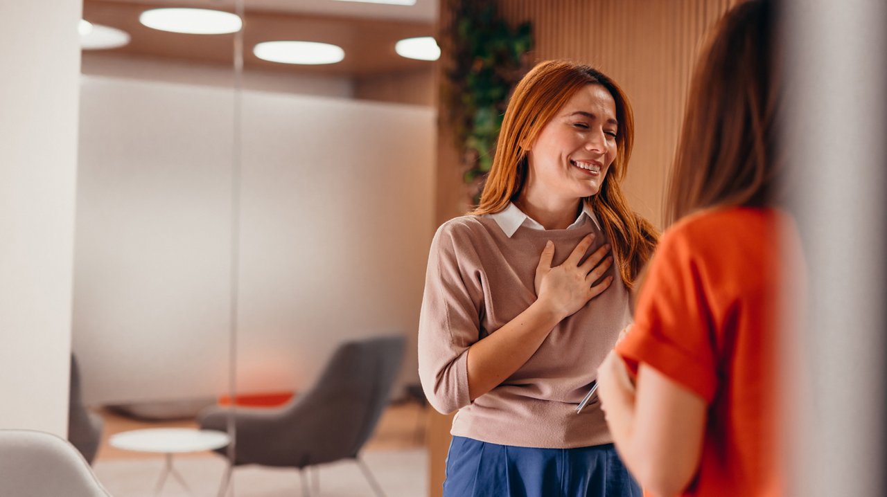 lady happily speaking to another person 